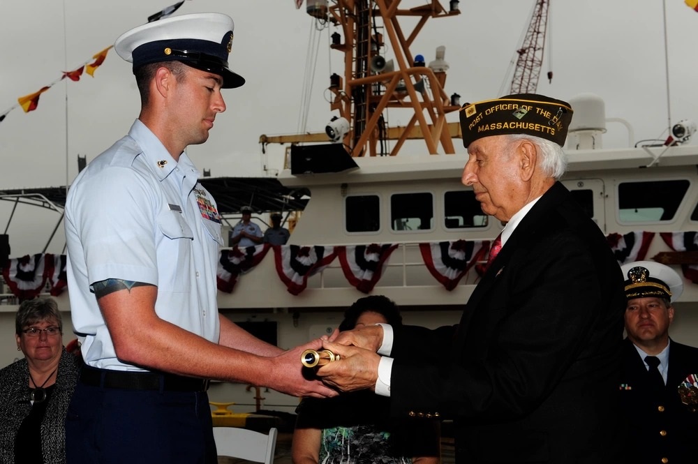 George Yered, father of Robert Yered, hands the long glass to Chief Petty Officer Stephen Kelly during the commissioning ceremony for Cutter Robert Yered. (U.S. Coast Guard) George Yered, father of Robert Yered, hands the long glass to Chief Petty Officer Stephen Kelly during the commissioning ceremony for Cutter Robert Yered. (U.S. Coast Guard)